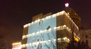 Giant Woody Guthrie projected onto Oklahoma Capitol Woody Guthrie